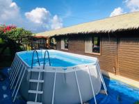 a swimming pool with a ladder next to a house at Kenting Summerland Garden Resort in Eluan