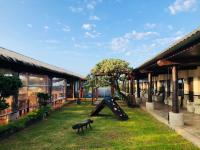 a playground in a yard next to a building at Kenting Summerland Garden Resort in Eluan