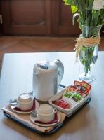 a tray with a tea set on a table at Hotel Tugasa Castillo de Castellar in Castellar de la Frontera