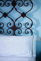 a bed with a black head board with a white pillow at Hotel Tugasa Castillo de Castellar in Castellar de la Frontera