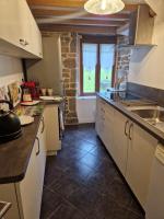 a kitchen with a sink and a counter top at La Bannerie in Mesnil-Clinchamps