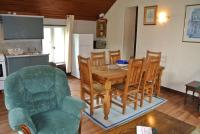 a kitchen and dining room with a table and chairs at La Bannerie in Mesnil-Clinchamps