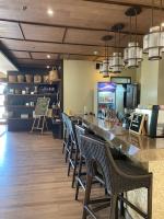 a restaurant with a bar with chairs and a counter at BristleRidge Near JohnHay Fast Wi-Fi Balcony in Baguio