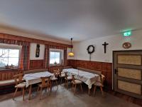 a dining room with two tables and chairs and a fireplace at Apartments HAUS SCHÖN - Preise inclusive Pitztal Sommer Card in Jerzens