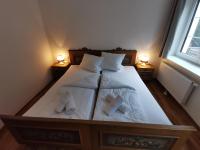 a bedroom with a bed with two towels on it at Apartments HAUS SCHÖN - Preise inclusive Pitztal Sommer Card in Jerzens