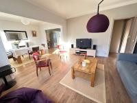 a living room with a couch and a table at Appartement de charme - Lorient in Lorient