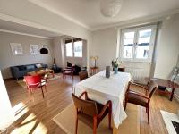 a living room with a table and chairs at Appartement de charme - Lorient in Lorient