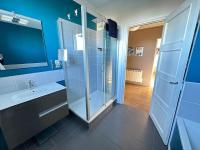 a bathroom with a glass shower and a sink at Appartement de charme - Lorient in Lorient