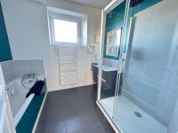 a bathroom with a shower and a tub and a sink at Appartement de charme - Lorient in Lorient