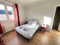 a bedroom with a bed with two towels on it at Appartement de charme - Lorient in Lorient