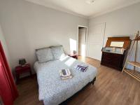 a bedroom with a bed and a dresser with two plates on it at Appartement de charme - Lorient in Lorient