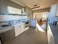 a kitchen with a sink and a stove top oven at Appartement de charme - Lorient in Lorient