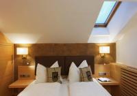 A bed or beds in a room at Residence Hotel Alpinum