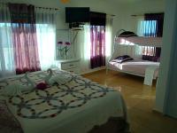 Postel nebo postele na pokoji v ubytování El Malecon B&B Hotel