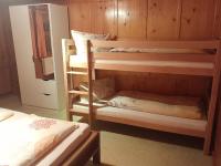a room with two bunk beds and a bed at Haus Silke in Silbertal