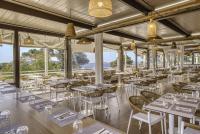 a restaurant with tables and chairs and windows at Belambra Clubs Presqu&#39;île De Giens - les Criques in Hyères