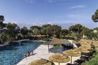 a pool with umbrellas and people sitting around it at Belambra Clubs Presqu&#39;île De Giens - les Criques in Hyères