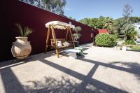 a patio with a bench and a swing at Belambra Clubs Presqu&#39;île De Giens - les Criques in Hyères