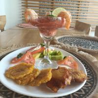 a plate of food with a drink on a table at Cristal Blue Barú in Baru