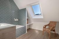 a bathroom with a sink and a chair and a window at Lumineuse et accueillante maison pour 8 personnes in Sarzeau