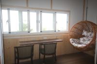 a bar with two chairs and a large window at Cingjing Vienna Pleasance Cottage in Ren&#39;ai