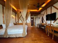 a bedroom with a bed and a flat screen tv at Cingjing Vienna Pleasance Cottage in Ren&#39;ai