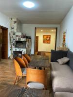 a living room with a couch and a table and chairs at Садиба Бабина Лоза in Lisove