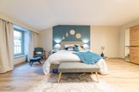 Łóżko lub łóżka w pokoju w obiekcie Les coursives appartements