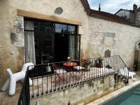 a balcony of a house with a table and chairs at Gîte des 3 Marchands in Buzançais