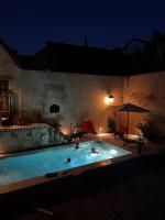 a group of people in a swimming pool at night at Gîte des 3 Marchands in Buzançais