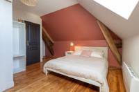 a bedroom with a bed in a attic at L&#39;Orée du Faubourg - VENDOME CENTRE in Vendôme