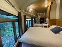 a bedroom with two beds and a large window at Linyuan Village in Jiufen