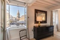 a room with a dresser and a mirror and a window at La Demeure du Clocher 4 - On the Port and Place St Catherine - 8 P in Honfleur