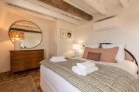 a bedroom with a bed with a mirror and a dresser at La Demeure du Clocher 4 - On the Port and Place St Catherine - 8 P in Honfleur