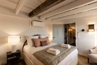 a bedroom with a large bed with towels on it at La Demeure du Clocher 4 - On the Port and Place St Catherine - 8 P in Honfleur