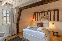 a bedroom with a white bed in a room at La Demeure du Clocher 4 - On the Port and Place St Catherine - 8 P in Honfleur