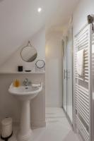 a white bathroom with a sink and a shower at La Demeure du Clocher 4 - On the Port and Place St Catherine - 8 P in Honfleur