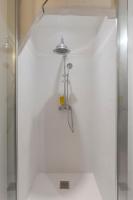 a shower in a white bathroom with a glass door at La Demeure du Clocher 4 - On the Port and Place St Catherine - 8 P in Honfleur