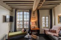 a living room with a couch and a large window at La Demeure du Clocher 4 - On the Port and Place St Catherine - 8 P in Honfleur