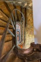 a view of a spiral staircase in a building at La Demeure du Clocher 4 - On the Port and Place St Catherine - 8 P in Honfleur
