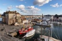 a group of boats docked in a marina with buildings at La Demeure du Clocher 4 - On the Port and Place St Catherine - 8 P in Honfleur