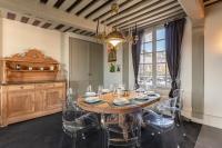 a dining room with a table and chairs and a chandelier at La Demeure du Clocher 4 - On the Port and Place St Catherine - 8 P in Honfleur