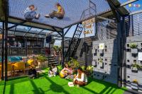 a group of people sitting on the grass in a building at Flock Kathmandu in Kathmandu