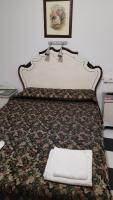 a bed with a white pillow sitting on top of it at Pensión San Benito Abad in Seville