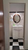 a bathroom with a sink and a mirror at Pensión San Benito Abad in Seville