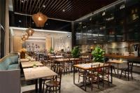 a restaurant with tables and chairs in a room at Hotel Traveltine Downtown Singapore, Trademark Collection in Singapore