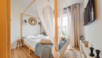 Posteľ alebo postele v izbe v ubytovaní Apartamenty Sun & Snow Port Krynica przy porcie i promenadzie