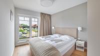Posteľ alebo postele v izbe v ubytovaní Apartamenty Sun & Snow Port Krynica przy porcie i promenadzie