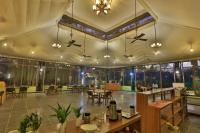 a restaurant with tables and chairs in a room at Rukhad Jungle Camp - Pench in Garhpahra