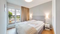 Posteľ alebo postele v izbe v ubytovaní Apartamenty Sun & Snow Port Krynica przy porcie i promenadzie